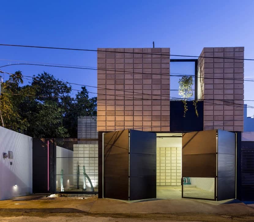 C-Shaped Concrete Block Home Wraps Around Swimming Pool Courtyard