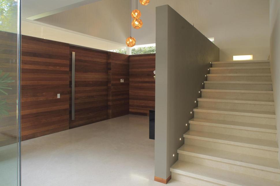 casa-siete-opens-wide-front-back-false-façade-16-foyer-steps.jpg