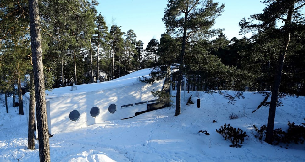 minimalist wood boat house floating in finland forest 1